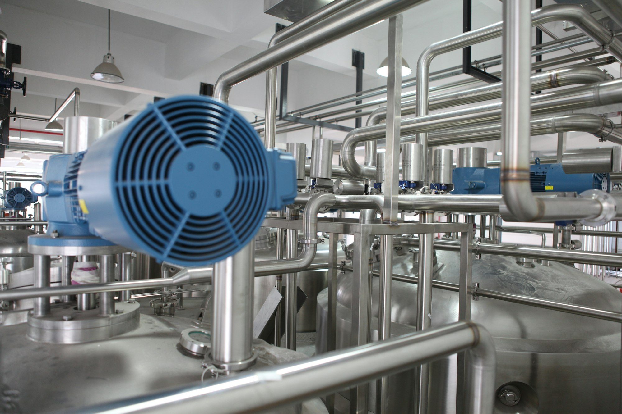 An electric motor among stainless steel process piping