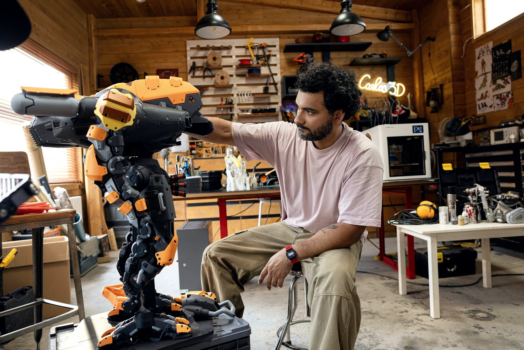 A maker building a robot in a workshop