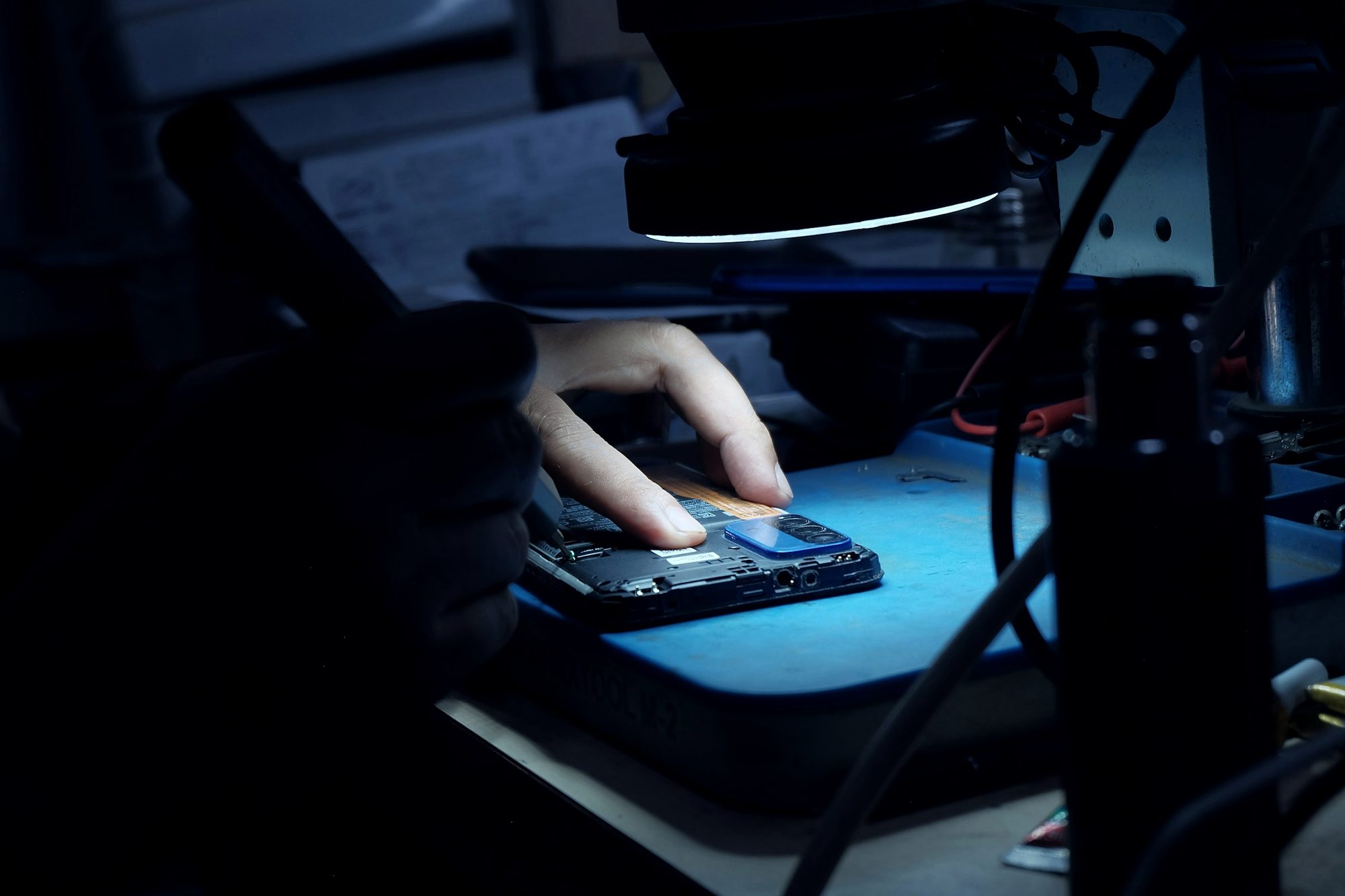 Hands at an electronics workbench